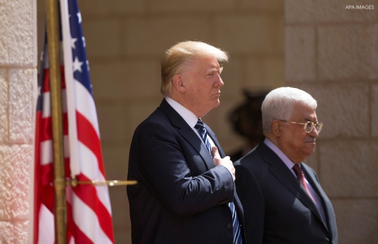 U.S. President Donald Trump and Palestinian President Mahmoud Abbas review the honor guard during a reception ceremony at the presidential headquarters